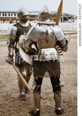 Two medieval knights in heavy armor are ready for battle. Modern reconstruction of ancient traditions and customs Two medieval knights in heavy armor are ready for battle. Modern reconstruction of ancient traditions and customs 81545325