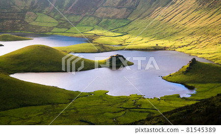 Landscape sunset view to Caldeirao crater, Corvo island, Azores, Portugal Landscape sunset view to Caldeirao crater, Corvo island, Azores, Portugal 81545389