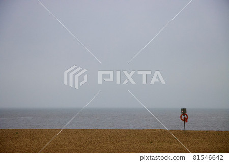 Scene at a beach with lifebuoy ring and lines of sand, sea and cloud 81546642