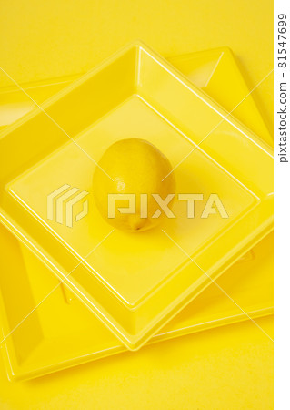 isolated lemon in yellow plates on yellow background 81547699