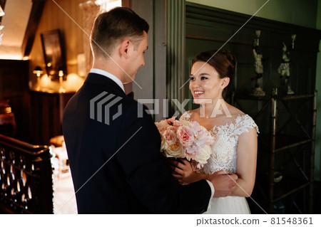 bride and groom in doorway during first meeting before wedding ceremony 81548361