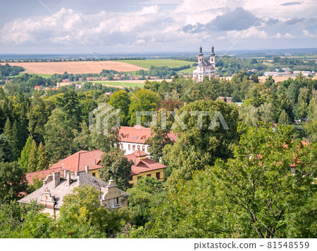 Luze village with Hamzova hospital roofs and baroque church 81548559