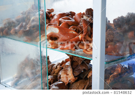 Closeup many pieces of stewed pork shown in the glass cabinet at the street food Closeup many pieces of stewed pork shown in the glass cabinet at the street food 81548632