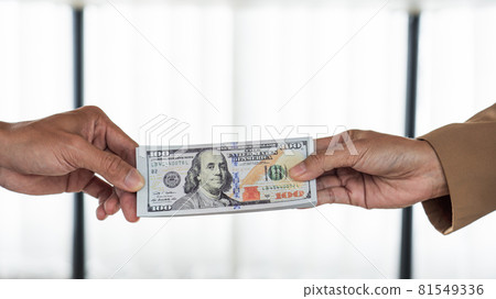 two hands passing bills making agreement to initiate the new business 81549336