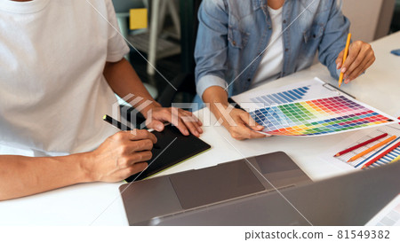 both coworkers designing some products choosing the appropriate shade both coworkers designing some products choosing the appropriate shade 81549382