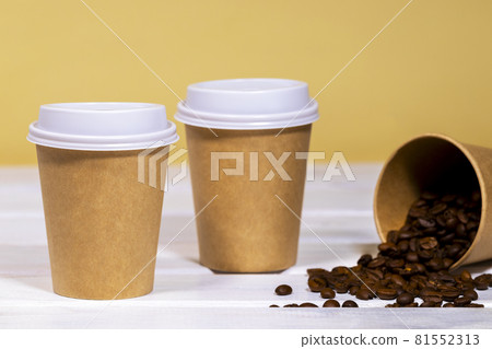 Coffee to go in paper eco cup with coffee bean on wooden and light orange background, Fast food, Copyspace Coffee to go in paper eco cup with coffee bean on wooden and light orange background, Fast food, Copyspace 81552313