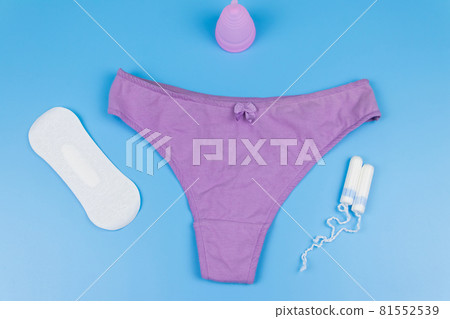 Women's panties with menstrual cups, sanitary pads and tampons on pastel blue background. Top view. Concept of critical days, menstruation, feminine hygiene 81552539
