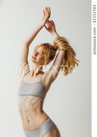 Half length shot of young woman with hands raised isolated over gray studio background. Natural beauty, authenticity concept. 81552565