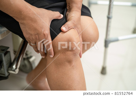 Asian middle-aged lady woman patient touch and feel pain her knee, healthy medical concept. Asian middle-aged lady woman patient touch and feel pain her knee, healthy medical concept. 81552764