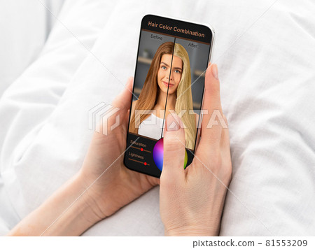 Woman choosing new hair color, using mobile app on cellphone Woman choosing new hair color, using mobile app on cellphone 81553209