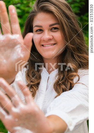 Young beautiful woman with a bright shining make up on a green meadow. High Fashion model woman in colorful bright silver sparkles. Glitter Vivid makeup Beautiful hair Girl. Healthy Long Hair 81553830