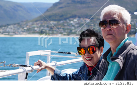 Asian senior elderly couple on tourist ferry boat to seals islan 81553933
