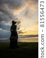 A woman standing at the sunset at Shimoumagahama beach in Fukuoka prefecture 81556473