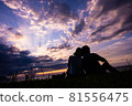 A couple watching the sunset at Shimoumagahama beach in Fukuoka prefecture 81556475