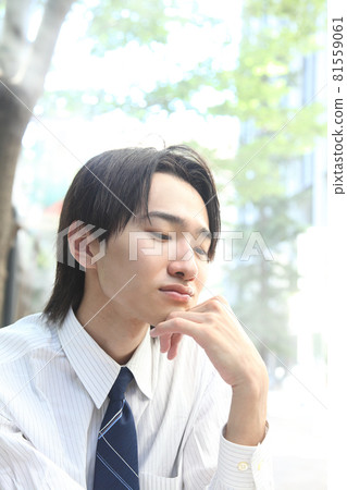 A young man with a straight face wearing a cheek stick from the bottom 81559061
