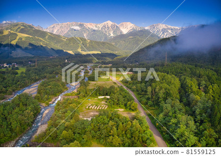 Majestic and beautiful early morning Shirouma Sanzan and Matsukawa Hakuba Village, Nagano Prefecture (aerial view by drone) 81559125