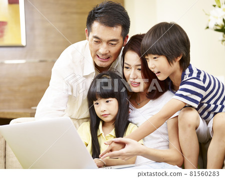 asian family with two children using laptop computer together asian family with two children using laptop computer together 81560283