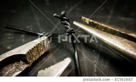 DIY twisted wire with pliers tool and worn-out workbench DIY twisted wire with pliers tool and worn-out workbench 81561687
