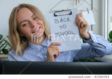 Young female teacher sitting at desk and using laptop at home. e Education Back to school. Student learning online class. Distance learning. Exam preparation 81564763