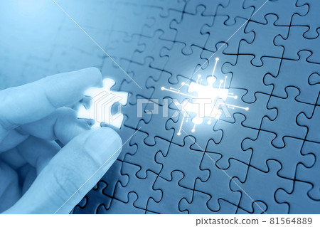 Hand filling missing piece of jigsaw puzzle Hand filling missing piece of jigsaw puzzle 81564889