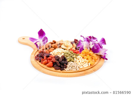 Group of various types of dried fruits and dried grains with beautiful orchid on a wooden plate isolated on white background. 81566590