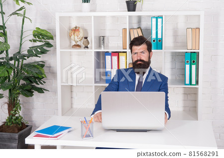 Managing business. Manager sit at office desk. Office manager work on computer. 81568291