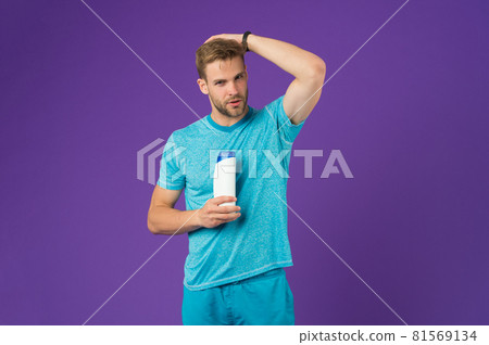 Man on confident face touching his hair, violet background. Man on confident face touching his hair, violet background. 81569134
