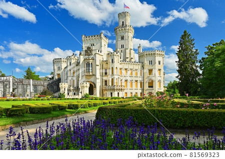Beautiful old state chateau Hluboka nad Vltavou. View from the outdoor garden in summer with blue sky, sun and clouds. Beautiful old state chateau Hluboka nad Vltavou. View from the outdoor garden in summer with blue sky, sun and clouds. 81569323