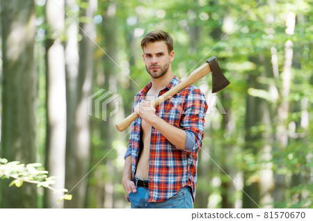 lumberjack in forest holding an axe on his shoulder, nature lumberjack in forest holding an axe on his shoulder, nature 81570670