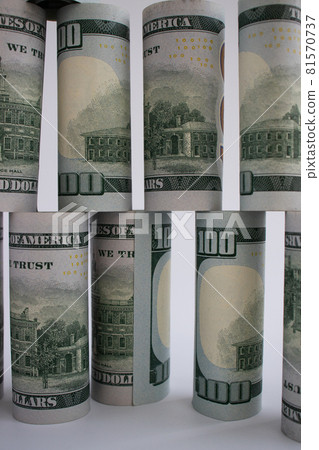 The wall from 100 dollars banknotes. Money construction. 81570737