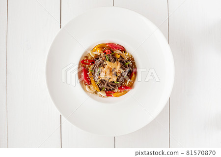 Soba noodles of buckwheat Noodles of buckwheat yellow pepper, tomato and herbs. Pan-Asian cuisine. Place for text. Square photo size. Soba noodles of buckwheat Noodles of buckwheat yellow pepper, tomato and herbs. Pan-Asian cuisine. Place for text. Square photo size. 81570870