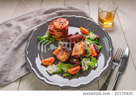 Hot Meat Dishes. Pork ribs grilled with salad and apples on a plate. 81570928