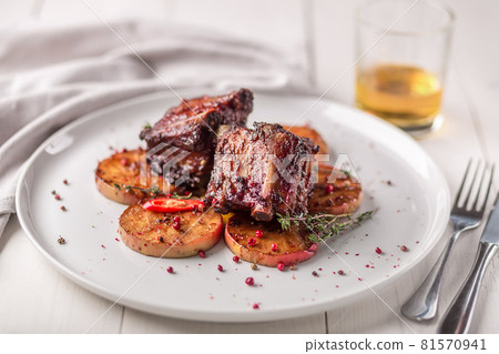 Hot Meat Dishes. Pork ribs grilled with peppers and apples Hot Meat Dishes. Pork ribs grilled with peppers and apples 81570941
