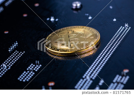 bitcoin physical shiner on black electronic board with selective focus and blur 81571765