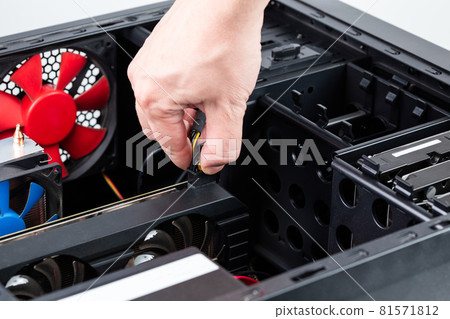 hand plugging aux power connector to the video card while maintenance personal computer hardware with selective focus 81571812
