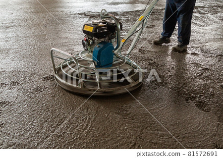 Power float grinder machine on wet concrete background closeup shot with selective focus and blur. 81572691