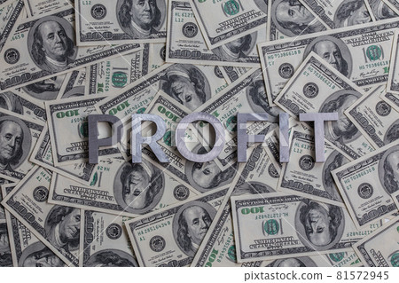 The word PROFIT laid with aluminium letters on the US dollar banknotes background - with selective focus The word PROFIT laid with aluminium letters on the US dollar banknotes background - with selective focus 81572945