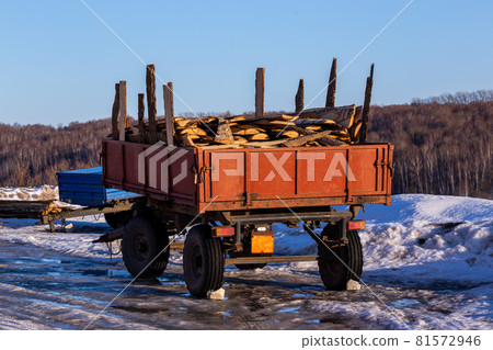 old rustic trailer with firewood lumber leftovers at winter daylight old rustic trailer with firewood lumber leftovers at winter daylight 81572946