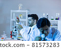 Team of research scientists analysing test trial new generation vaccine data. 81573283