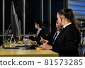 Businessman talking with team and working overtime late at night in call center office. 81573285