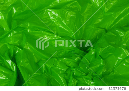 crumpled green polyethilene film abstract background with selective focus 81573676
