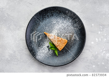 Top view of triangular piece of caramel cheese cake 81573934