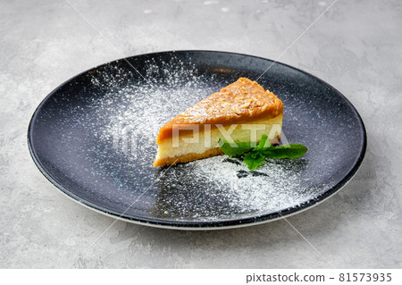 Triangular piece of caramel cheese cake 81573935