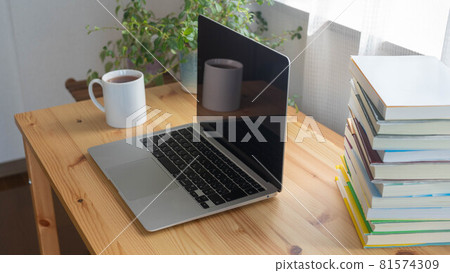 Laptops on the desk and piles of books | Work at home image Laptops on the desk and piles of books | Work at home image 81574309