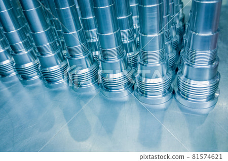 Shiny blue steel parts background, long clean steel rods after fine cnc turning. 81574621