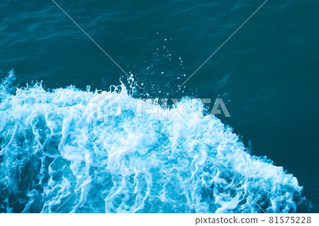 White crest of a wave in the dark turquoise water of the ocean White crest of a wave in the dark turquoise water of the ocean 81575228