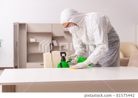 Young male contractor doing pest control at home Young male contractor doing pest control at home 81575442