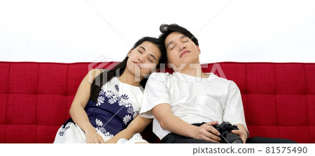 Asian couple falling asleep on the sofa after finishing the photo shoot in the studio. 81575490