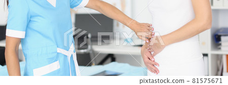 Gynecologist doctor palpating sick abdomen of young woman 81575671