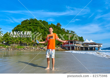 happy tourist guy on the central beach in Langkawi tropical island 81575946